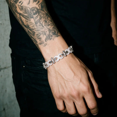 Silver 13MM Cruciata bracelet worn on a tattooed wrist