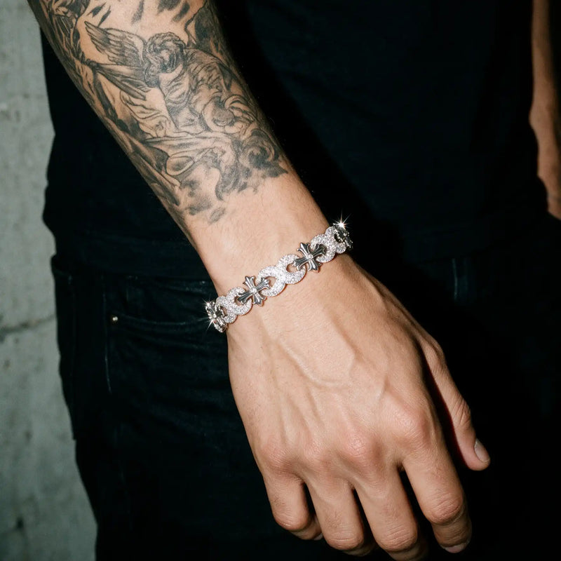 Silver 13MM Cruciata bracelet worn on a tattooed wrist