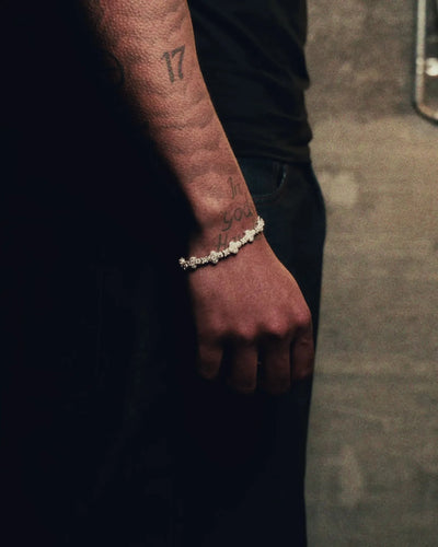 Silver 10MM Fortuna Clover bracelet worn on a tattooed wrist