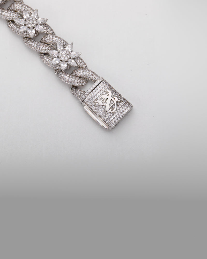The clasp of the silver 15MM Flora Fatale Cuban chain, showing the monogram