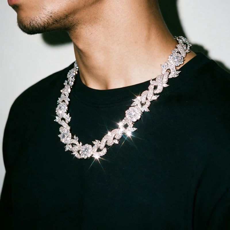 Silver 15MM Rosa Spinosa chain worn over a black tee, seen from the side